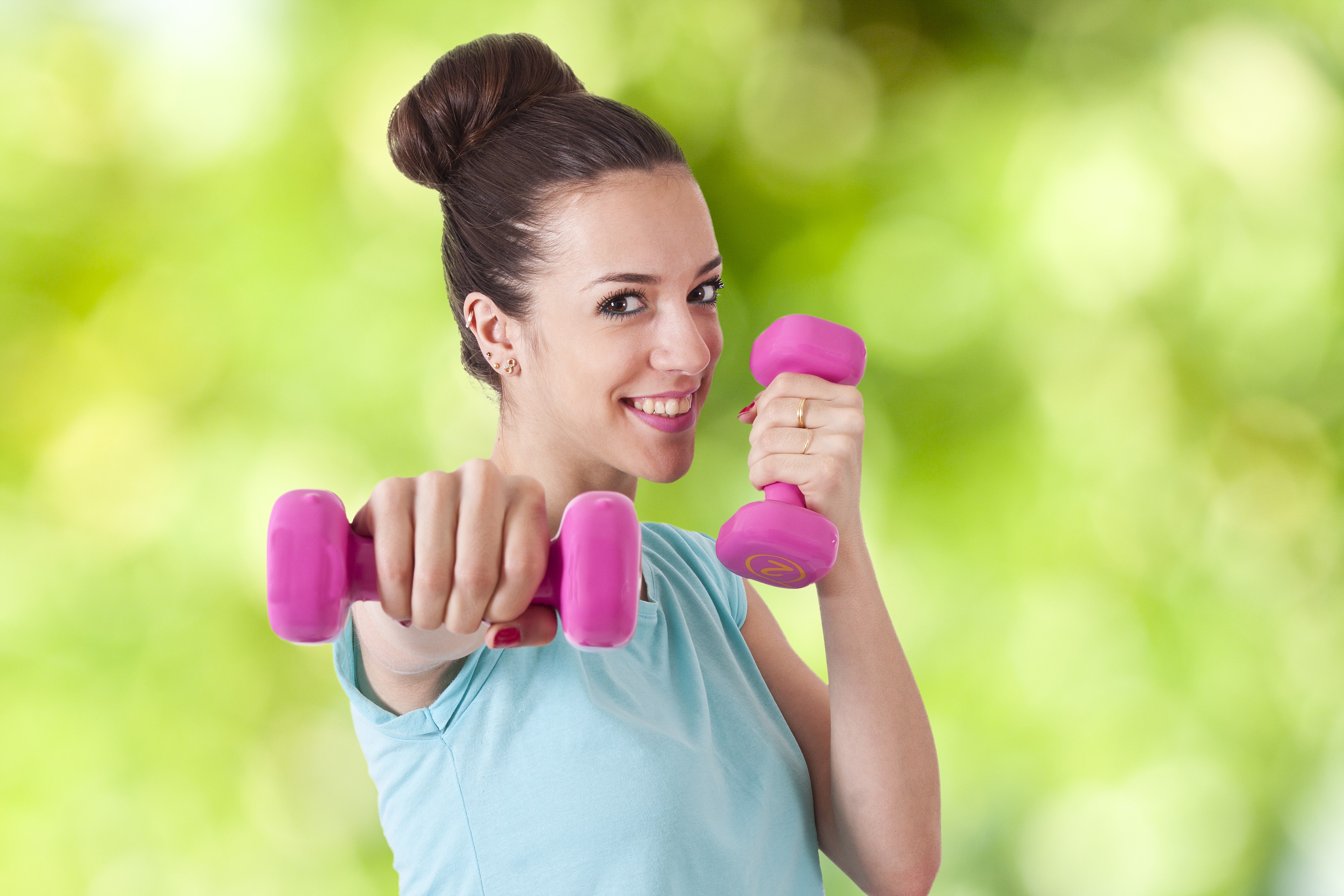Woman Holding Pink Dumbbells